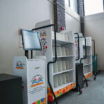 shelves and kiosk containing books that are ready for customer pickup