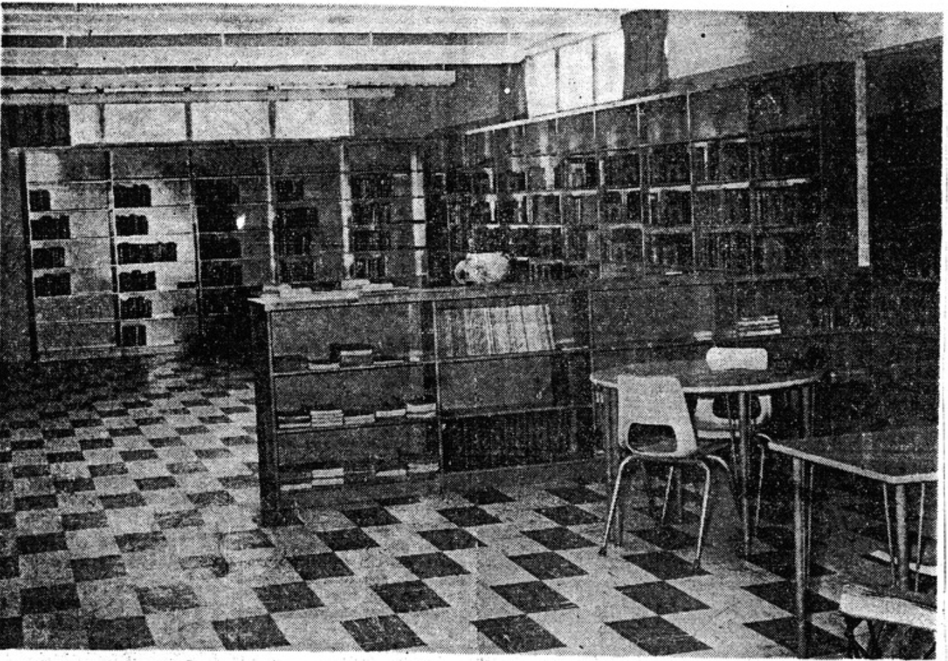 inside of weaver library 1961 - bookshelves and a table