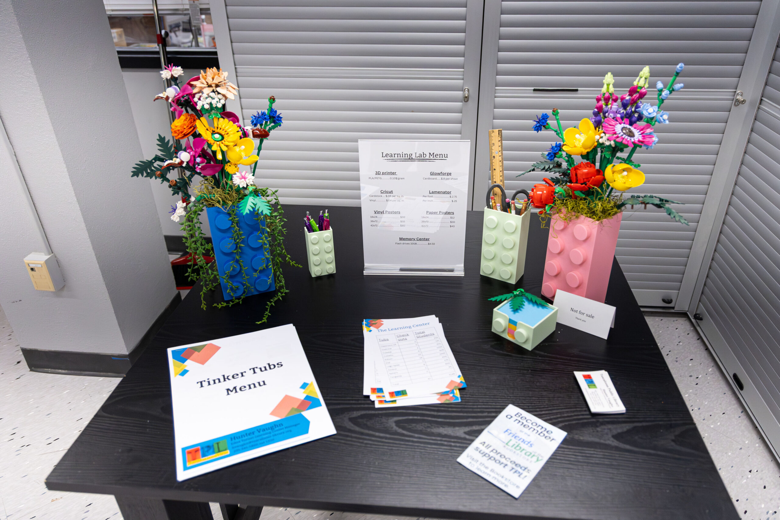 Examples of Lego shaped vases with signs advertising the Learning Center