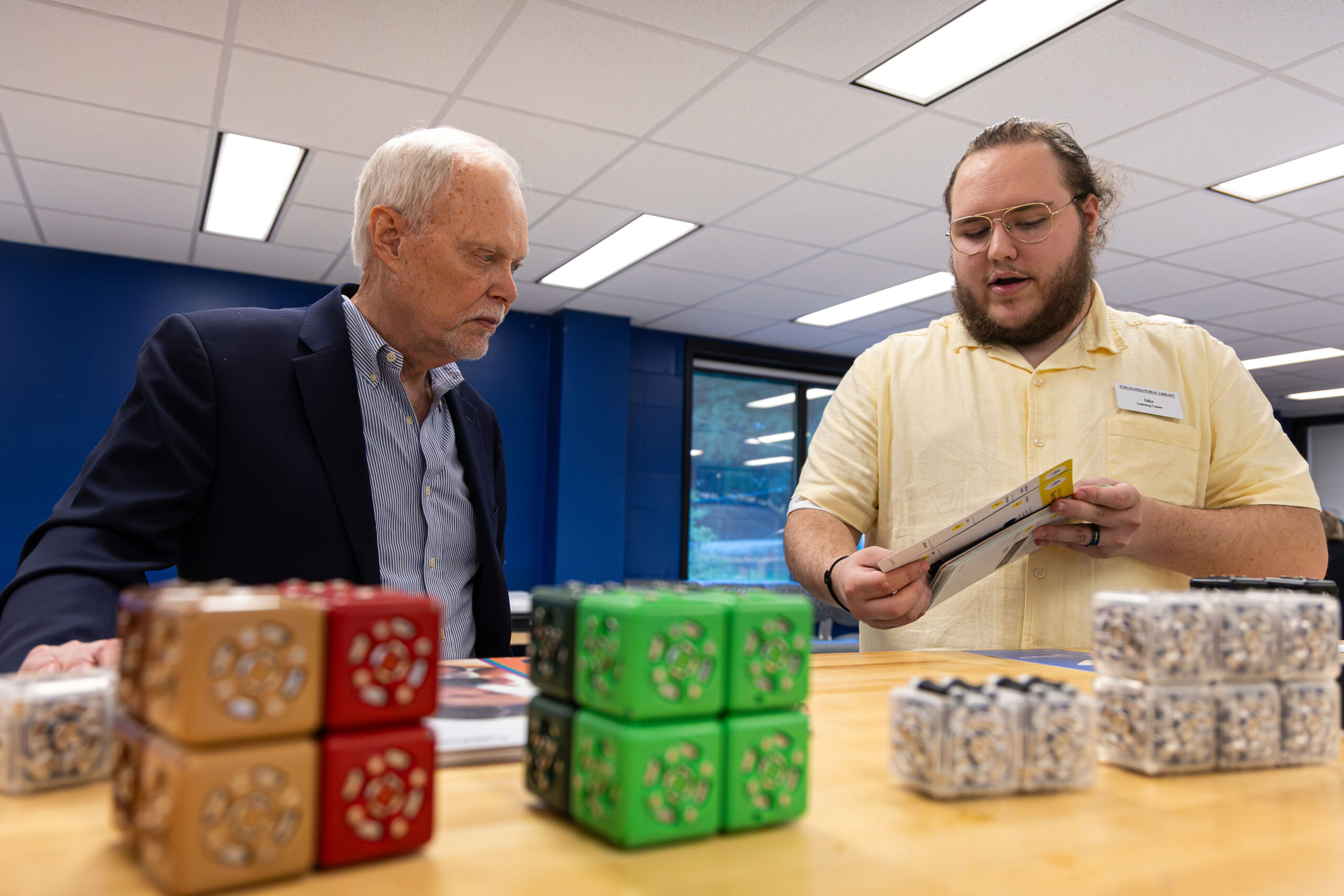 A staff member demonstrating some of the robotic toys used for school educational programs