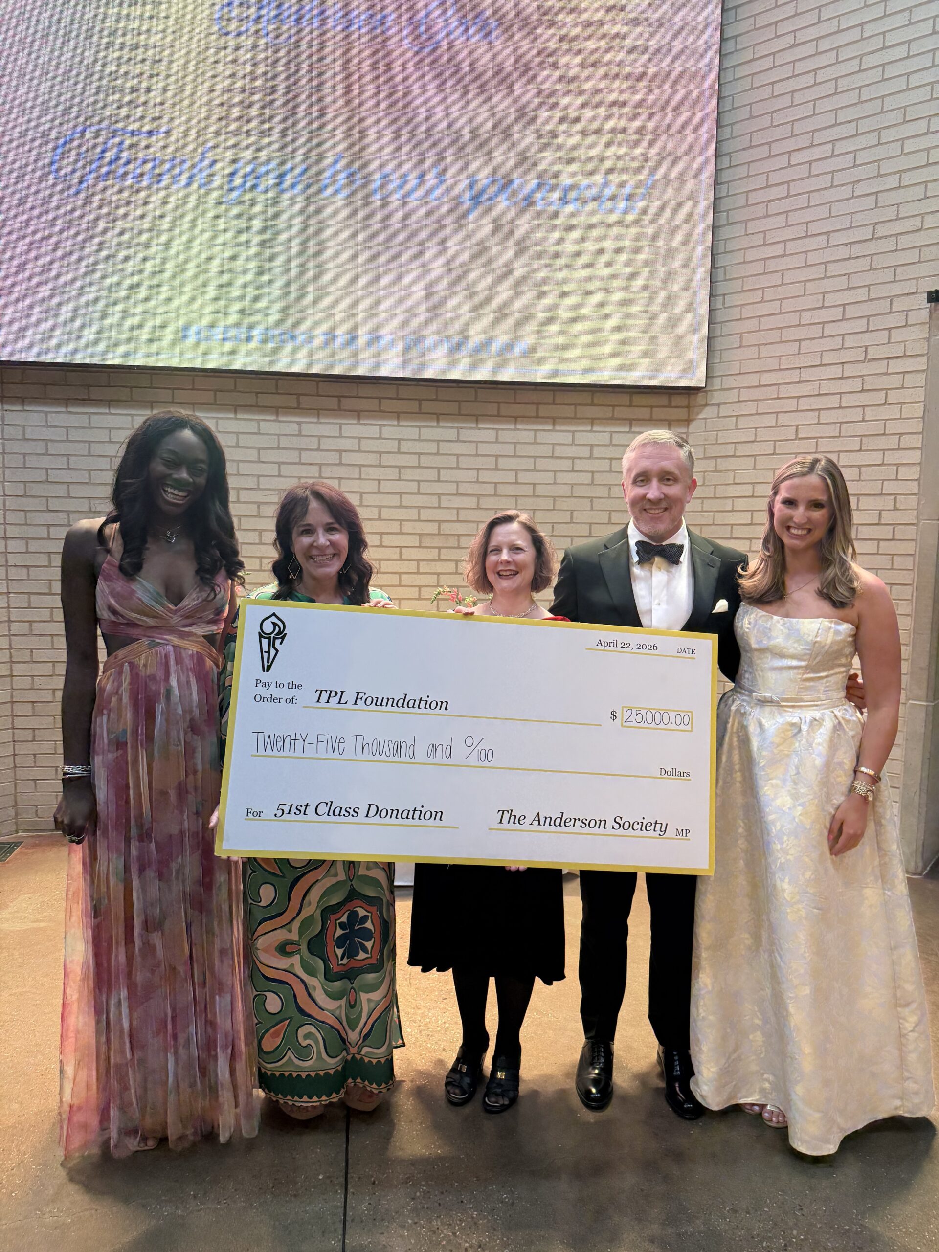 Board Foundation members receiving a check from the Anderson Society for $25,000